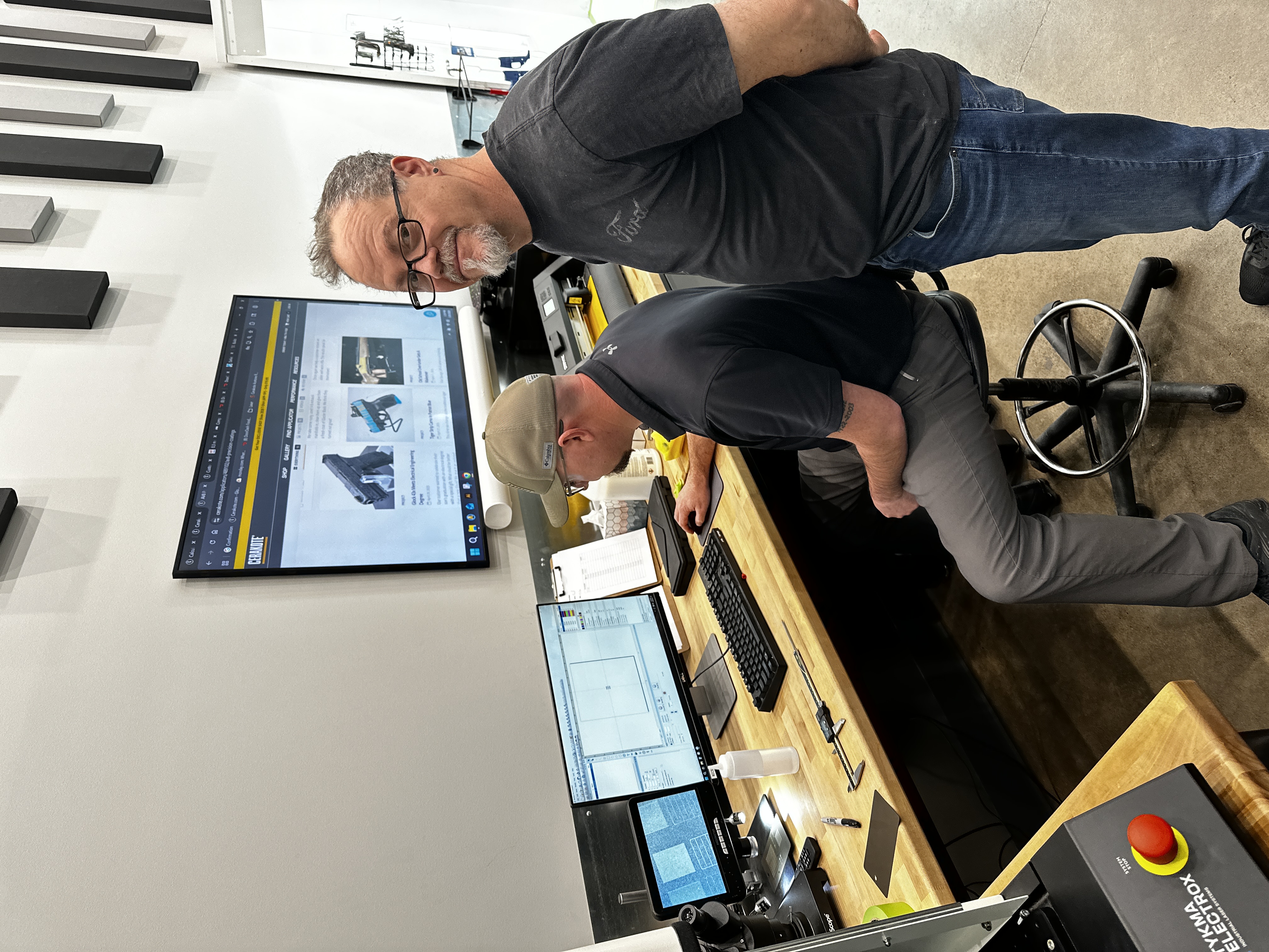 Frederick Plummer II with his Cerakote laser instructor at NIC Industries advanced laser training, January 2026