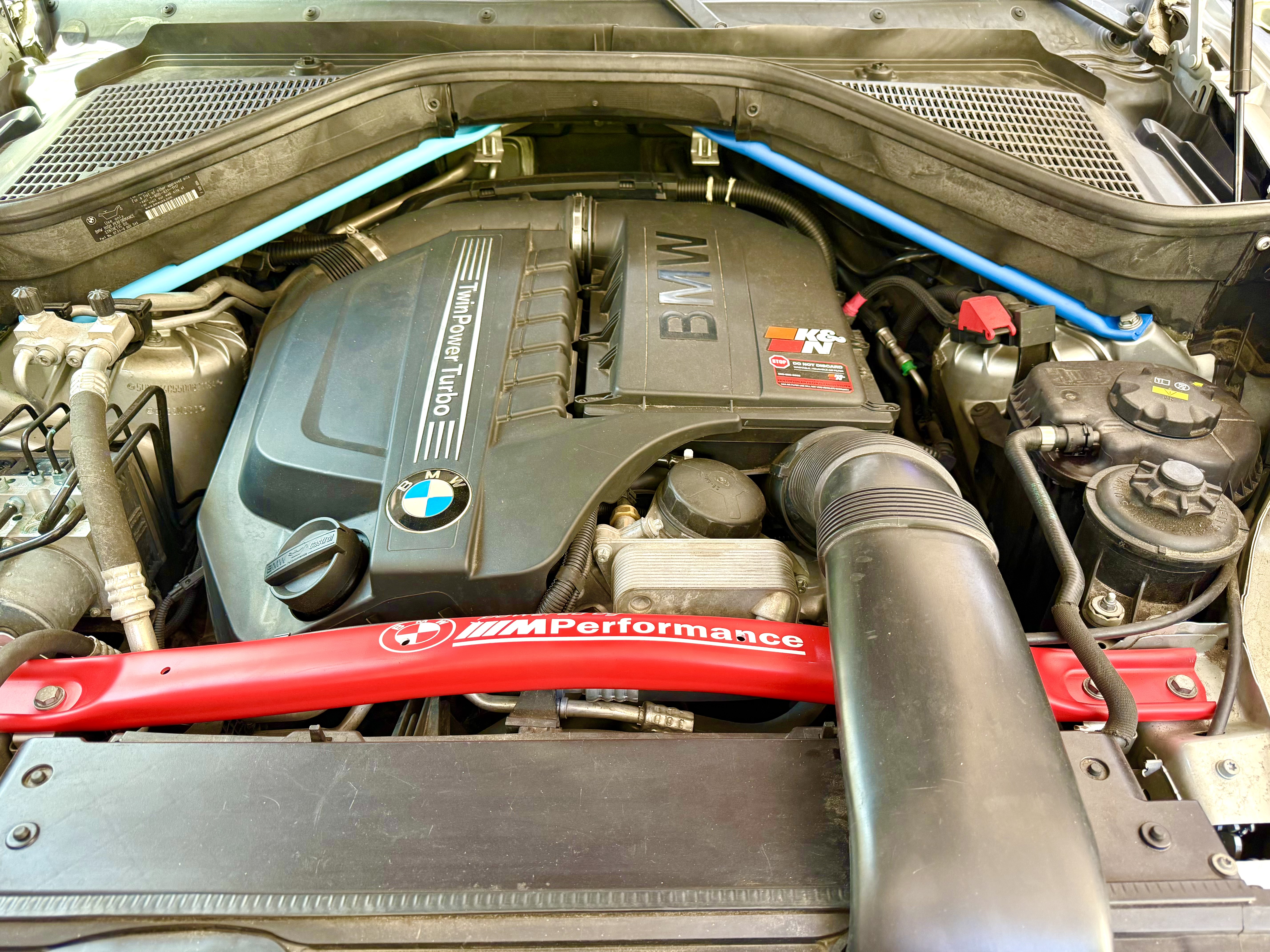 BMW X5 M Performance cross bar and strut bars Cerakoted in red and blue