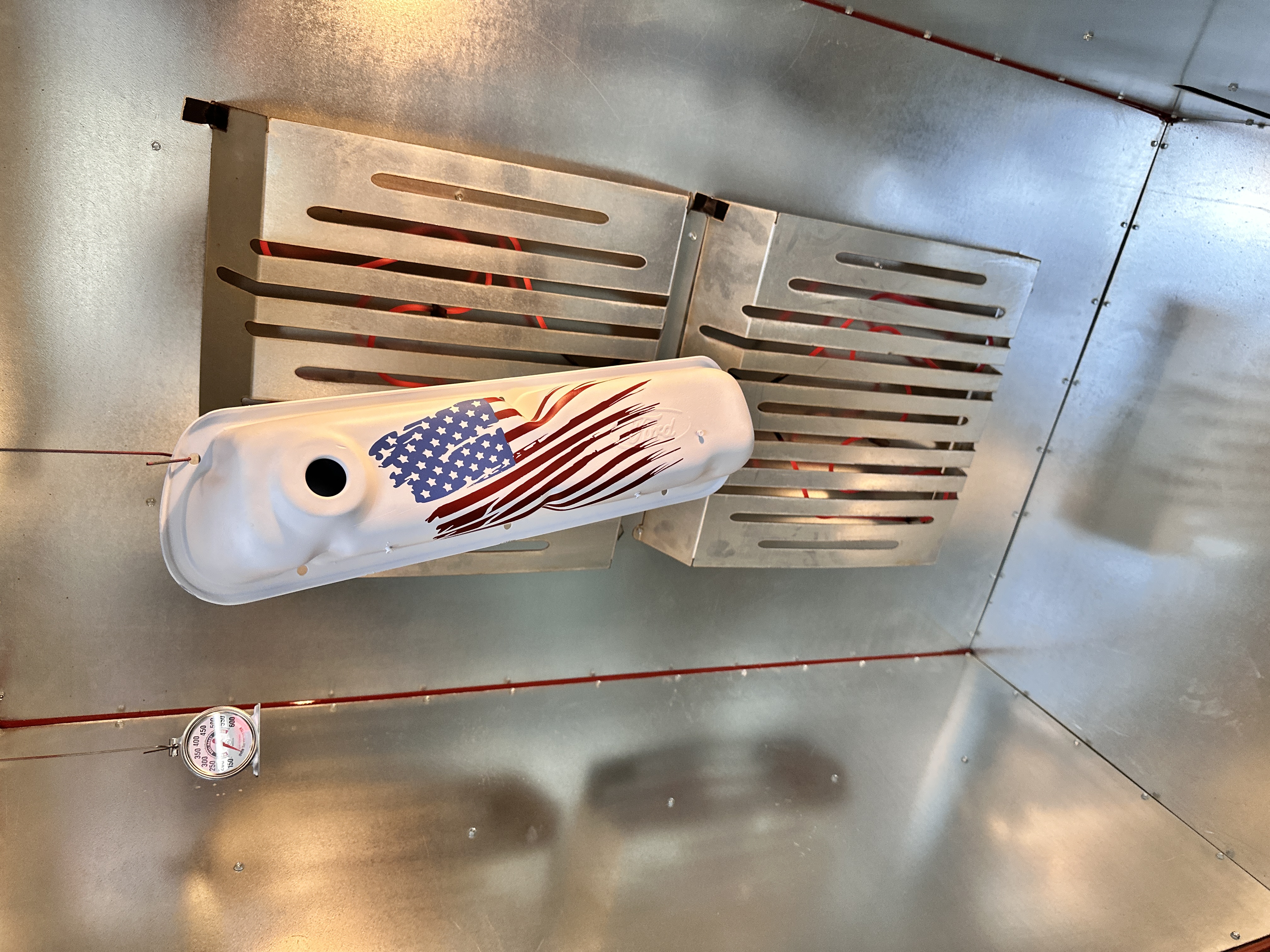 American flag valve cover curing in the Cerakote oven at AV8
